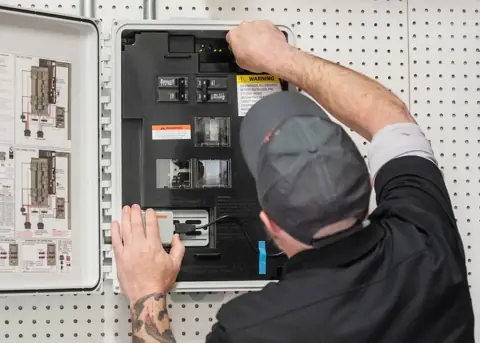 Home battery backup system mounted on a wall