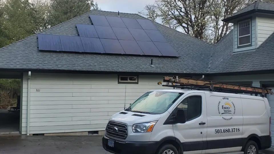Home solar panels on a garage with an Energy Solutions van in front