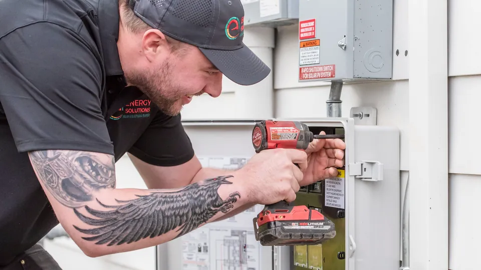 Energy Solutions electrician working on an outdoor electrical panel