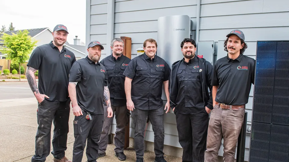 The Energy Solutions crew beside a customer home