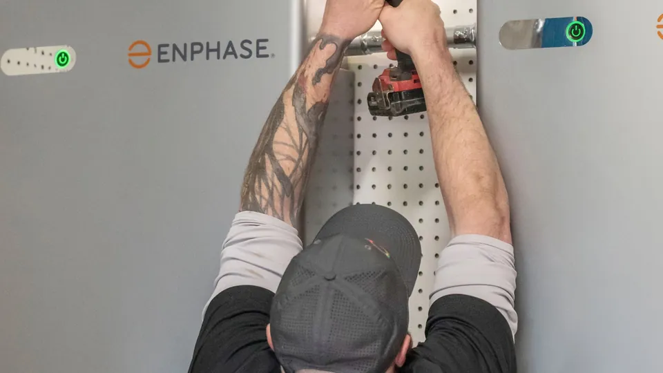 Energy Solutions electrician mounting Enphase home batteries