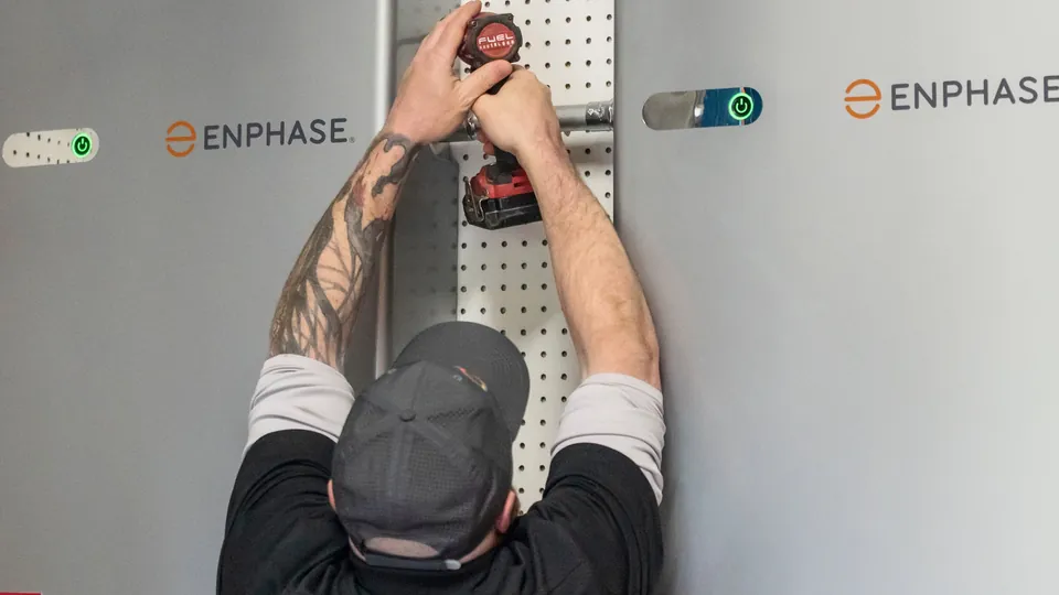 Energy Solutions electrician mounting Enphase home batteries