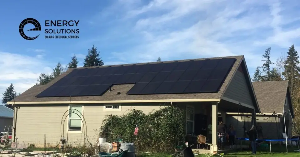 Home with black solar panels under a blue sky