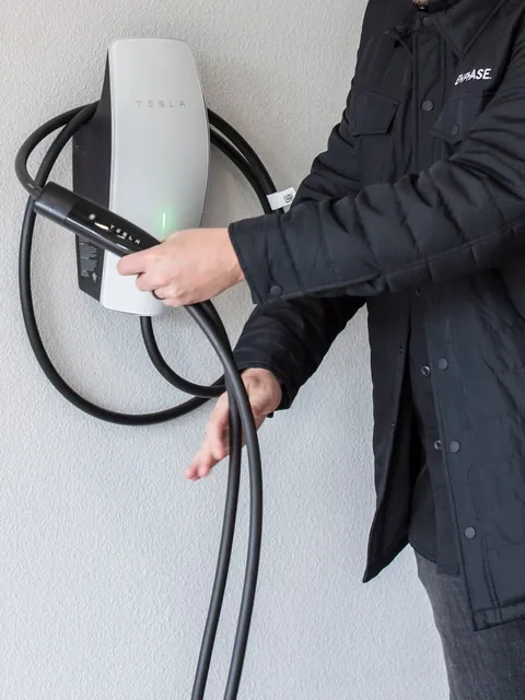Home EV charger installed next to an electrical panel