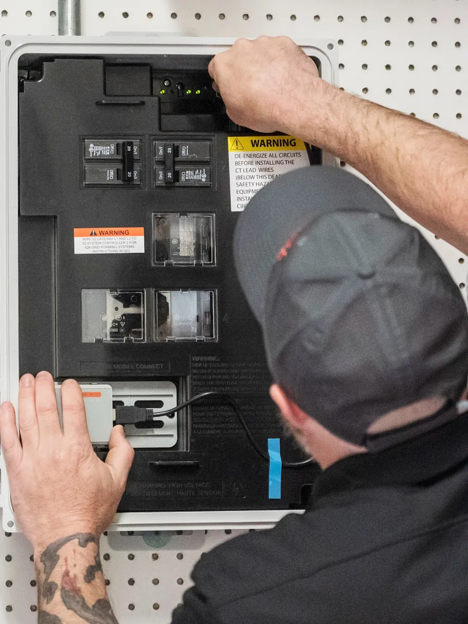 Energy Solutions electrician working in an electrical panel