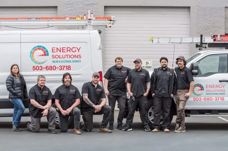 The Energy Solutions crew standing with the company vans