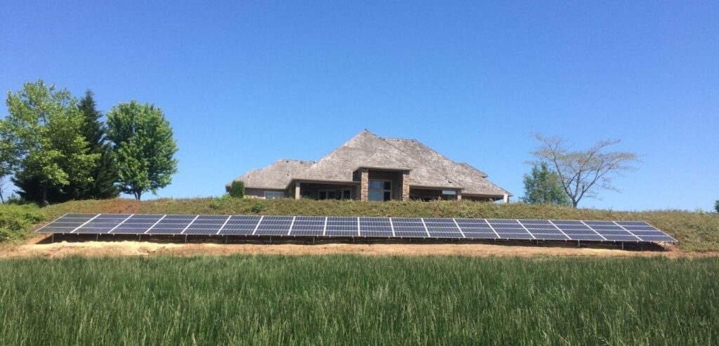 home ground mounted solar system in front yard on a blue sky day