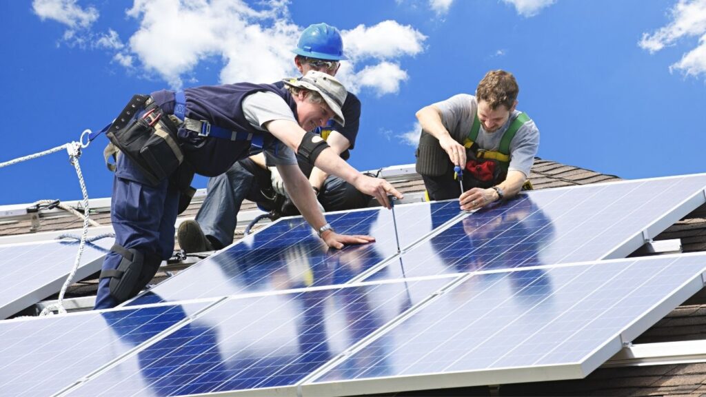 multiple solar installers working on the roof together