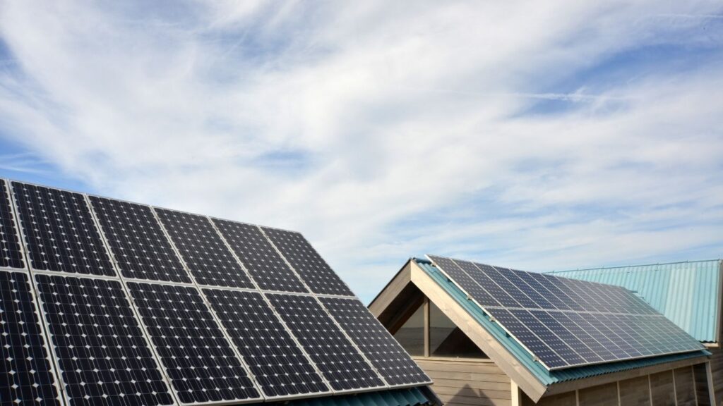 two roofs with solar panels