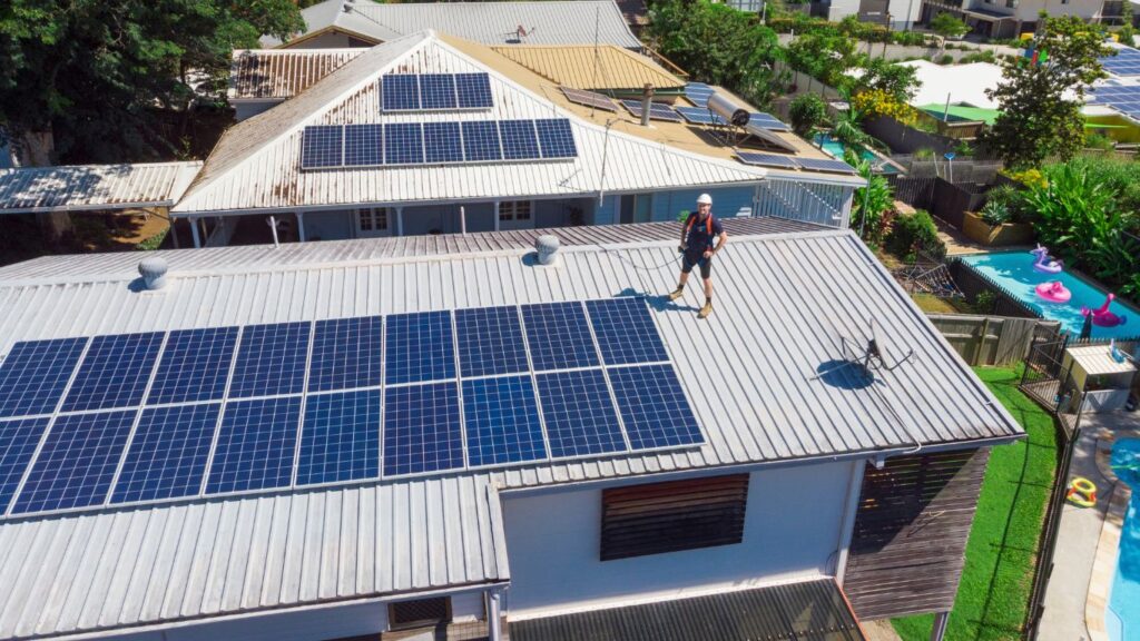 Portland solar installer standing next to a home solar system