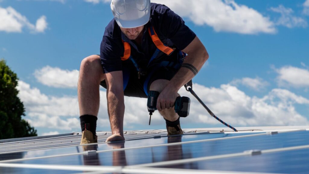 man removing solar panels