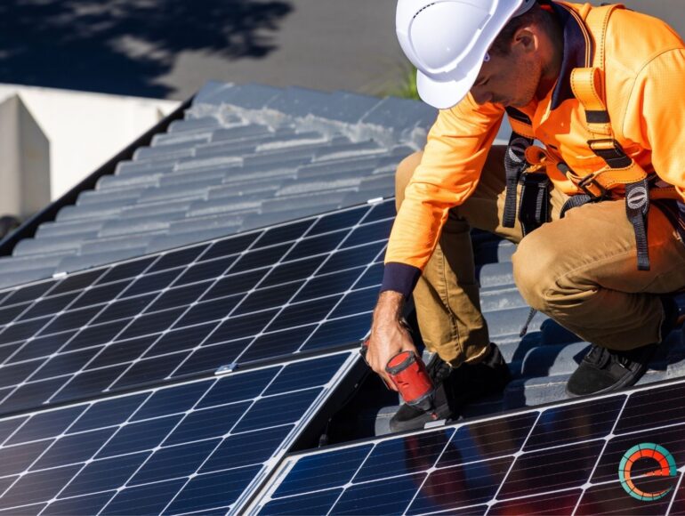 a person working on solar panels on a roof