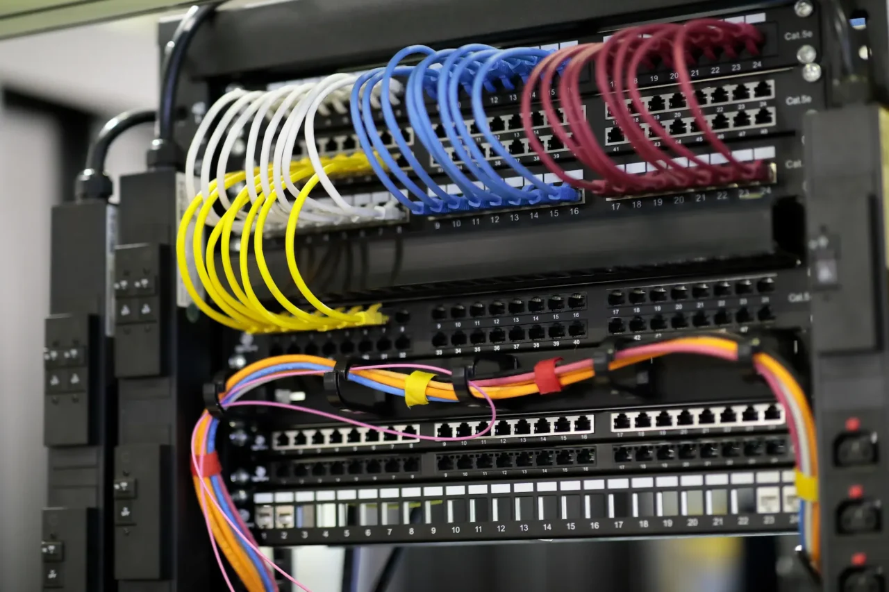 Colorful ethernet cables neatly organized in server rack.